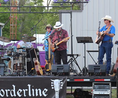  Local band South Loup Sunrise, under the lead of Clifford Badgley - far right - performs at the 2022 Blowin’ the Doors Off BBQ. Badgley vividly recalls the frightening night of Oct. 31, 2000 - that prompted the annual celebration. (Courier photo by Ellen Mortensen)