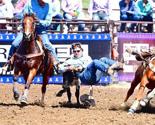 Dawson Doggett dismounts his horse onto a steer during the National High School Rodeo Finals in Wyoming. Doggett finished in 17th place overall, after leading at the end of the first go. (Photos courtesy MaKayla Doggett)