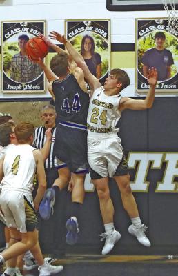 Crew Witthuhn fights off a defender at the basket. (Courier photo by Ronda McFate)