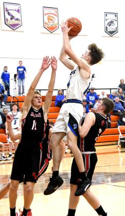 Far right: Senior Cache Gracey takes to the air elevating over Maverick defenders. Right: Senior Lance Wooters weaves through Maverick traffic for a clean shot before the buzzer sounds in Maxwell (Courier photo by Loleta Connell)