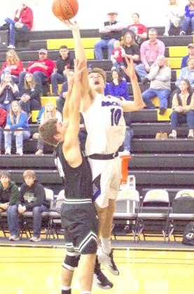 LEFT: Dylan Pandorf goes over the top of a Sandhills-Thedford defender for a basket during their conference match-up on Saturday.