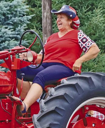 Kay Fahnholz could not contain her joy as she drove one of her and her husband Darrell’s antique tractors through the Callaway parade. The couple’s children and grandchildren also drove some of the tractors in what has become an annual family tradition. (Photos courtesy Janel Brestel)