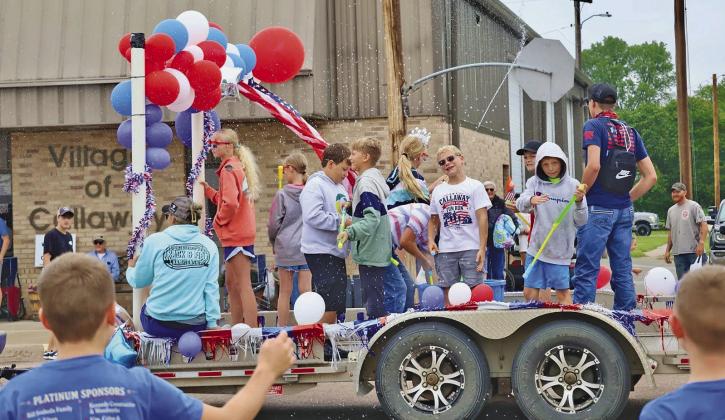 Though it was overcast and still a little cool at parade time, that did not keep these kids from taking aim at the crowd with their water guns! (Photo courtesy Janel Brestel)