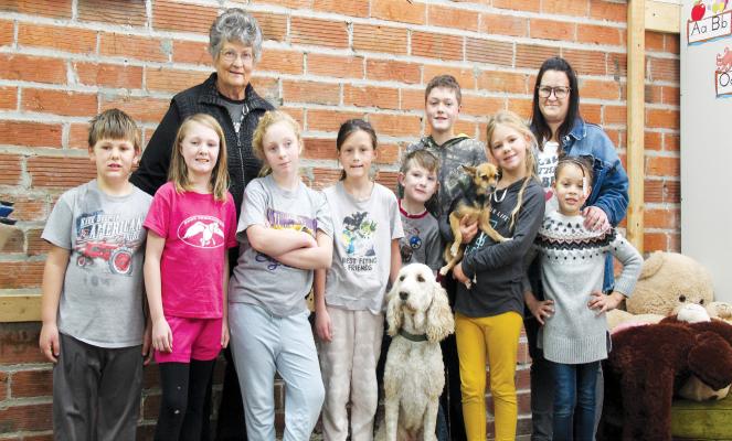 Pictured, from left, are Callaway Christian Academy students Owen Brown, Grace Stutzman, Johanna Edwards, Palynn Hinman, Gideon Stutzman, (poodle Zion) Gabe Stutzman, Paisley Brown (holding Elliott) and Jae’Lynn Eastman. Teachers in the back row are Carol Watson, left, and Morgan Hinman. Student Christian Mills was absent. (Courier photo by Ellen Mortensen)