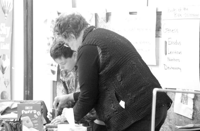 Carol Watson works with a student at Callaway Christian Academy. (Courier photo by Ellen Mortensen)