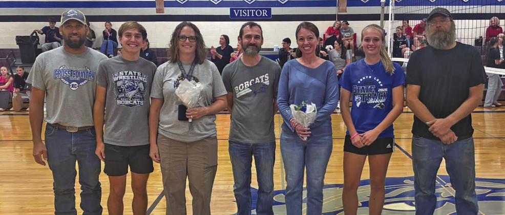 The two senior members of the 2026 South Loup cross country teams were honored, along with their parents, during the volleyball game on Oct. 9. Pictured from left are: Roy Bierman, Walter Bierman, Melissa Bierman, Leighton Jones, Elizabeth Jones, Jade Bierman, and Wayne Bierman. (Photo courtesy CPS)