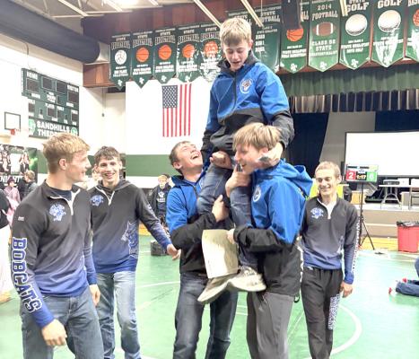 The Bobcat wrestling team celebrates after winning the MNAC Championship in Thedford on Saturday. (Courier photo by Brandy Mason)