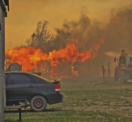 Sara Hogg snapped this photo from her yard as volunteer firefighters fought to save her home. They lost the garden shed, but are very grateful that their house still stands.