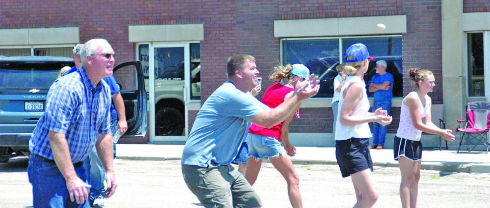 Prepared to catch an egg tossed by Landon Kaup (not pictured) in the Oconto Fun Day Egg Toss is Scott Dvorak, center. To the left, Rick Dvorak looks for a toss from grandchild Skylar Dvorak (not pictured).