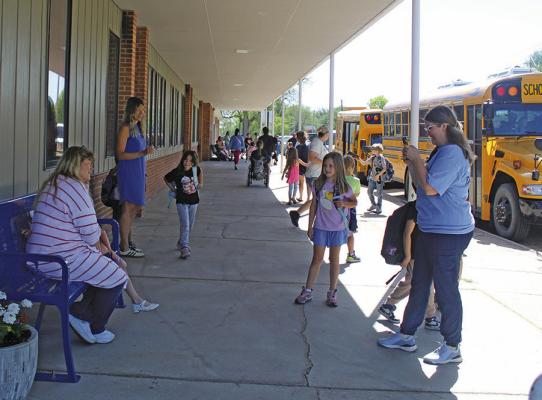As students exited the building on the last day of school on May 15, some stopped for a photo with their teacher. Callaway students earned an early out by greatly improving their test scores from the previous year, a fun incentive that benefits all. (Courier photo by Ellen Mortensen)