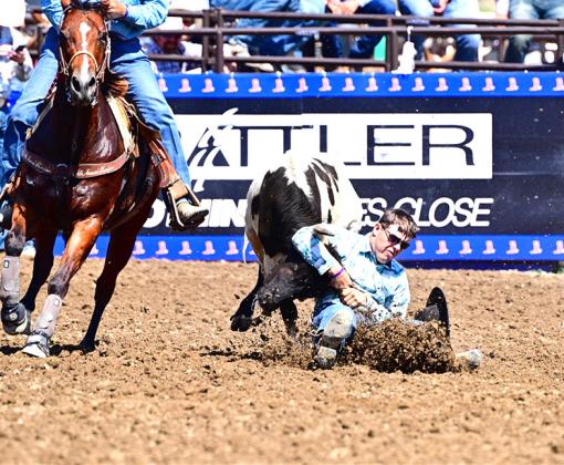 Dawson Doggett works to wrestle his steer to the ground in a faster time than his competitors during the National High School Rodeo Finals. Doggett plans to continue his rodeo career and is hoping to earn his pro rodeo card.