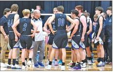 The South Loup boys’ basketball team huddles around Coach Jeff Cole during the game against Pleasanton last Saturday. The Bobcats are still looking for their first win of the season. (Courier photo by Ronda McFate)