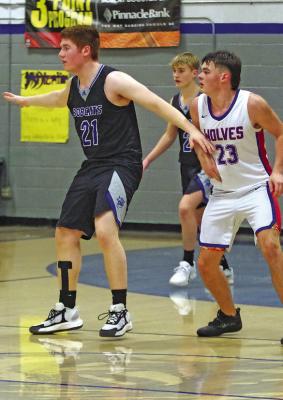 Malachi Neth (#21) and Tysen Schacher guard under the Arthur County basket for the Bobcats.