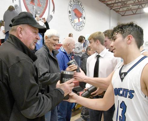 Four “ultimate Bobcat fans” were thanked by the South Loup boys’ basketball team for their support as the team presented each of the four gusy with their own personalized mug. Team members took the opportunity to personally thank each of them. (Courier photo by Loleta Connell)