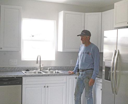Rod Brestel stands in the new kitchen of a Callaway home that he and Henry Moore remodeled recently. The house was uninhabitable and is now a beautiful home, made possible by a new grant program through the Callaway Economic Development and Village Board. (Courier photo by Ellen Mortensen)