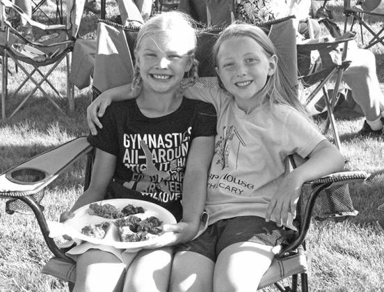 My grandaughter Ellie, right, and her cousin Kya, enjoying each other and good BBQ in Oconto. (Courier photo by Ellen Mortensen)