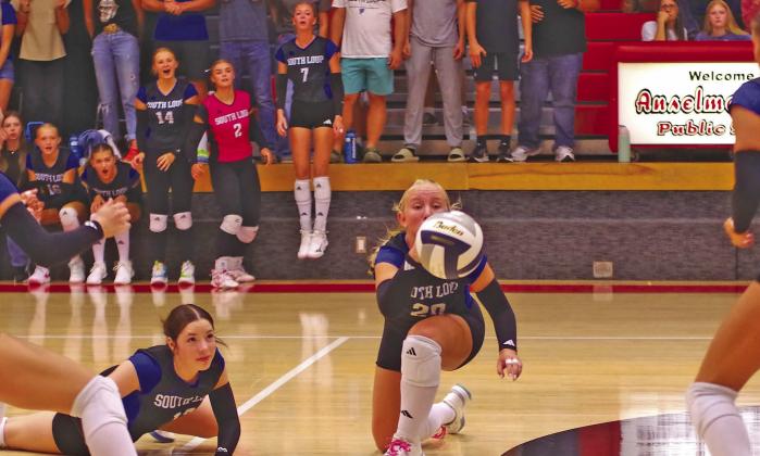 Asa Starr (#20) and Olivia Fitzgerald (#13) try to get to the ball to keep it in play during a South Loup volleyball match. The Lady Bobcats played five matches last week. (Courier photos by Ronda McFate)