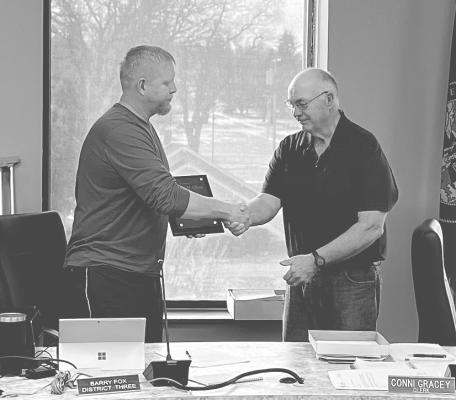County Board of Supervisors Chairman Barry Fox, left, presents a plaque to Don Olson in appreciation of his many years of service on the county board. (Photo courtesy Sandhills Express)