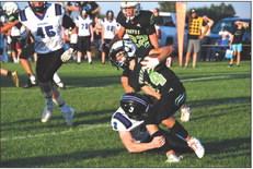 Senior Trey Connell wraps up M/HC ball carrier Grady Erickson.