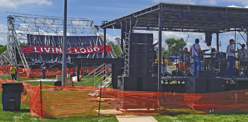 The small stage typically used as the sound booth for Livin’ Out Loud was transformed into the main stage Saturday, while the collapsed large stage remained visible in the background. (Courier photos by Ellen Mortensen)
