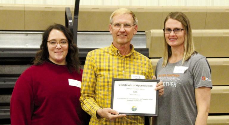Randy Meyer accepted the certificate for 60 years of business in Callaway from Chamber board members Kelsey Wyckoff, left, and Stacey Guthard.