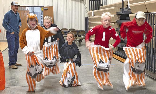The competitive spirit comes out in the kids as they run the sack race.