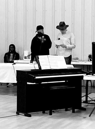 A variety of skits were performed during the evening of old time radio entertainment, including “The Further Adventures of Wyatt Earp and Annie Oakley”. Wyatt Earp was played by Uotong Haidle, left, Black Bart was Joel Karg, right, and Nyachay Haidle (seated) read the part of Annie Oakley.