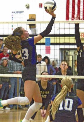 Berklee Preston tries to tip the ball over the hands of the Ansley/Litchfield defender in last week’s match. (Courier photos by Ronda McFate)