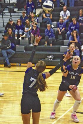 Josie Lehmkuhler (#7) sets up the ball for Emma Stallbaumer (#18) with Addison Dalrymple (#16) in the background.