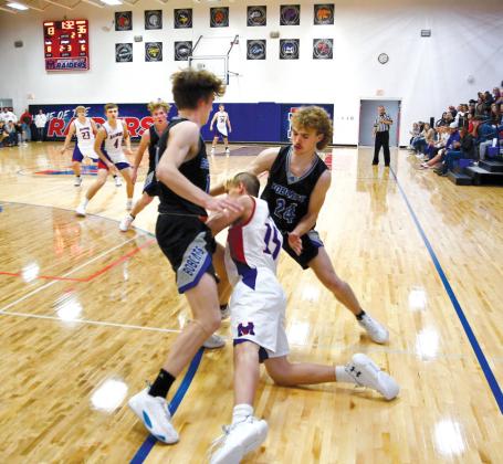 Junior Cache Gracey and sophomore Harper Johnson set the trap for Kaden Weaver.