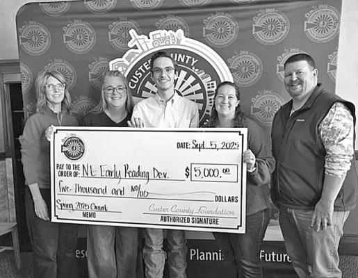 Pictured are members of the Custer County Foundation Board presenting a check to an Arnold student and his teacher. From left are Kim Schipporeit, Arnold teacher Nicole Badgley, AHS senior Eli Rogers, Rilee Daffer, and Chris Smith. (Photo courtesy Custer County Foundation)