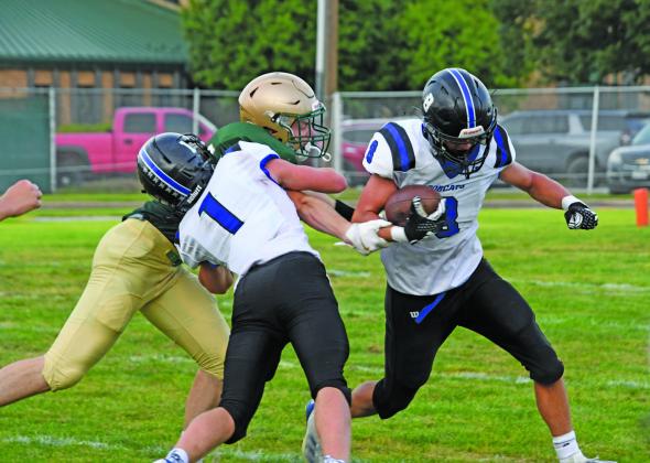 Elijah Cool (#8) runs to the outside with a big block from quarterback Tysen Schacher (#1). (Courier photos by Leta Connell)
