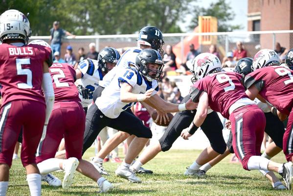 Harper Johnson (#13) prepares to block the Hi-Line defender to protect his quarterback on a handoff during Friday night's game. (Courier photos by Jessica Tickle)