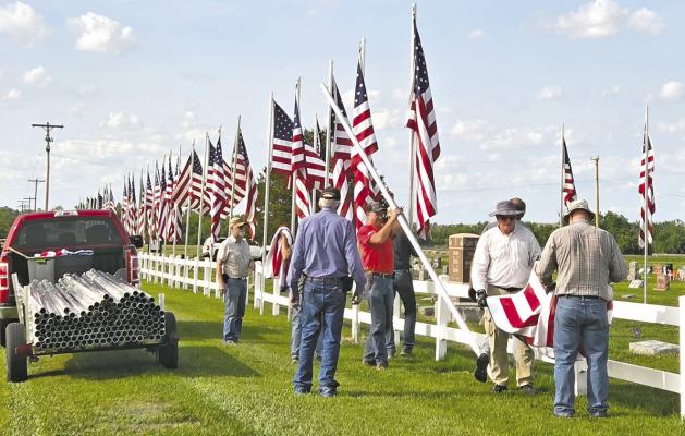 Members of the Callaway American Legion take down the flags and poles at Rose Hill Cemetery after Memorial Day. (Photo courtesy Jo Chesley)