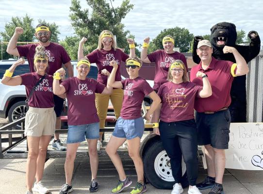 Callaway Public Schools' new superintendent JD Furrow, far right, got in on the Pioneer Picnic fun by joining staff members on the school's parade float. Front row, from left, Wendy Dockweiler, Amanda Fetters, Denise Sughayar, and Jenn Hickenbottom; back row, Principal Heath Birkel, Principal Brittany Jesseph, Melissa Eggleston, and Furrow. (Courtesy photo)