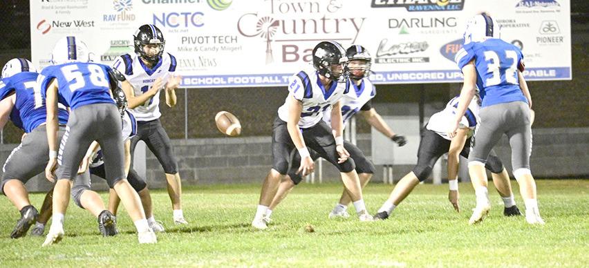 ABOVE: The Bobcats continued to chip away at the Ravenna lead Friday night with plays like this one by Dylan Pandorf to gain extra yardage. The game went into overtime with the Bobcats claiming the win. BELOW: Jamie Tickle starts the play by passing the football to Dylan Pandorf. (Courier photo by Jessica Tickle)