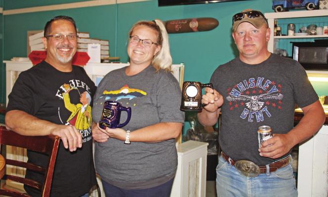 Henry Moore presents the first and second place awards for the Henry’s Bar 2nd Annual Salsa Contest to Rochale Schriner and Joe Schriner Sunday evening. Courier photo by Ellen Mortensen