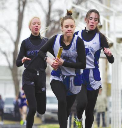(Right) Heidi Donegan gets out quickly after receiving the baton from Talliana Martin in the 3200 meter relay. Donegan and Martin teamed up with Ella Cool and Ivy Tulis for gold in the event with a time of 14:03.51. (Courier photos by Jessica Tickle)