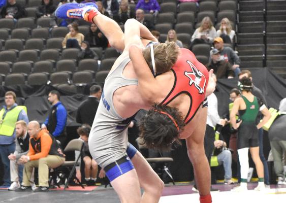 Dawson Mason shows his strength as he manhandles his opponent and throws him to the mat during the opening rounds of the Nebraska State Wrestling Championships on Feb. 15. Mason went on to win the fifth place medal at 132 pounds. (Courier photo by Morgan Mraz)