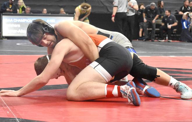 Top Right: Josiah Coleman goes for a takedown on the Franklin wrestler at 106 pounds Class D at the state tournament in Omaha last week. Coleman won the match. Right: Dawson Doggett works to get his opponent onto the mat for extra points and a potential pin. (Courier photos by Morgan Mraz)