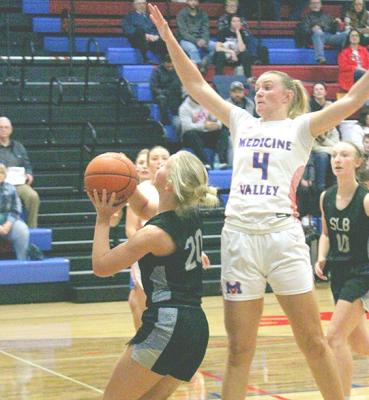 ABOVE LEFT: Addie Stump drives the ball to the basket for South Loup against Medicine Valley last week. ABOVE RIGHT: Asa Starr looks to take a shot under the basket. (Courier photod by Ronda McFate)