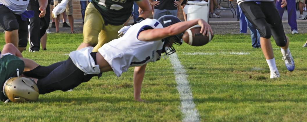 South Loup quarterback Tysen Schacher reaches for extra yardage in the Bobcats’ opening game of the football season on Aug. 28. Schacher led his team to victory on September 3rd at home as he garnered 3 touchdowns on 98 yards rushing. (Courier photo by Leta Connell)