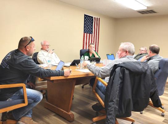 Callaway Village Board members, clockwise from left, TJ Elliott, Lawrence Paulsen, City Clerk Lori Bonde, Chairman Mark Kimball, Abe Hinman, and Dan Lewandowski discuss the agenda at the Dec. 10 board meeting. (Courier photo by Ellen Mortensen)