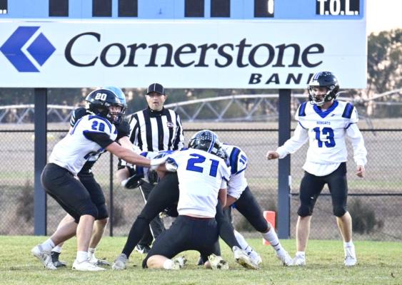 AJ Starr, Jamie Tickle and Conner Paulsen stop a Summerland Bobcat from getting the 2-point conversion. (Courier photos by Jessica Tickle)