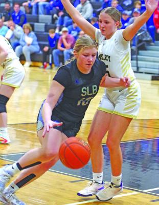 Tyra Brestel drives the ball toward the hoop for the Bobcats. (Courier photo by Ronda McFate)