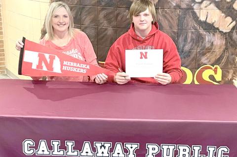 Joey Sallach is joined by his mom, Kim, as he signs his letter of intent to attend the University of Nebraska at Lincoln to study agribusiness. (Photo courtesy CPS)